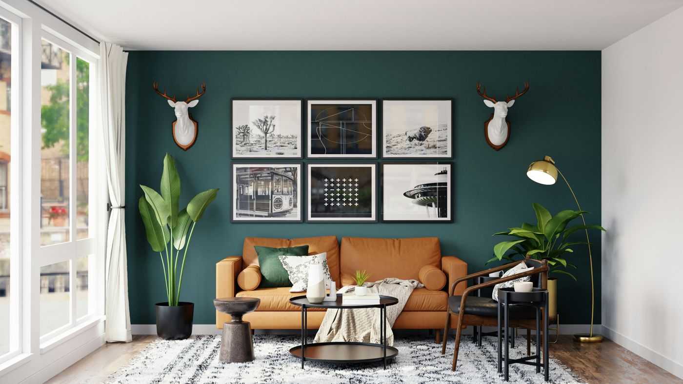 Gallery wall of framed art above a leather sofa